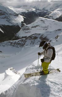 Skier perched on Delirium Dive, Sunchine,Alberta